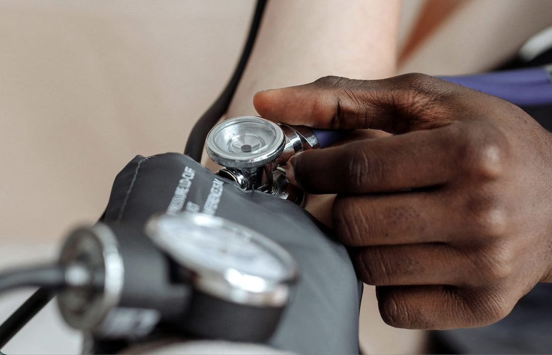 Healthcare professional using blood pressure monitor